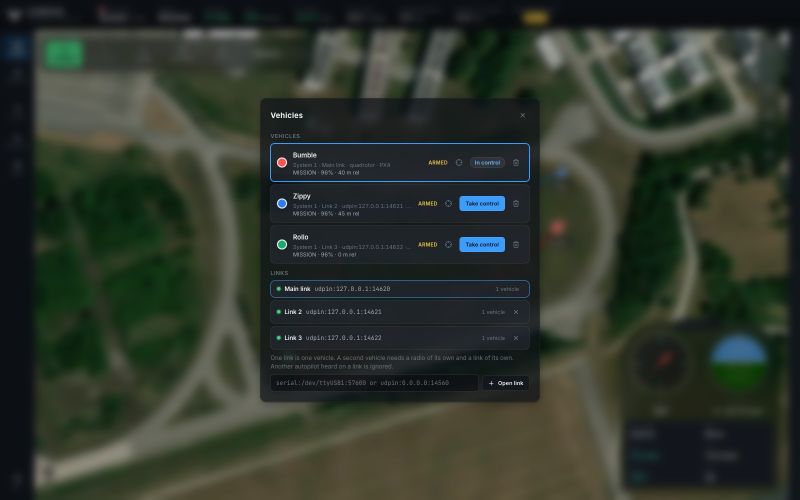 The Vehicles dialog in the blue theme listing Bumble in control, and Zippy and Rollo each with a Take control button, with their mode, battery and height, and the three links below with a field to open another one.